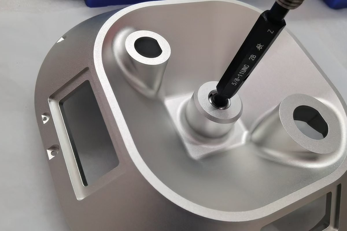 A measurement probe positioned against a machined component during inspection