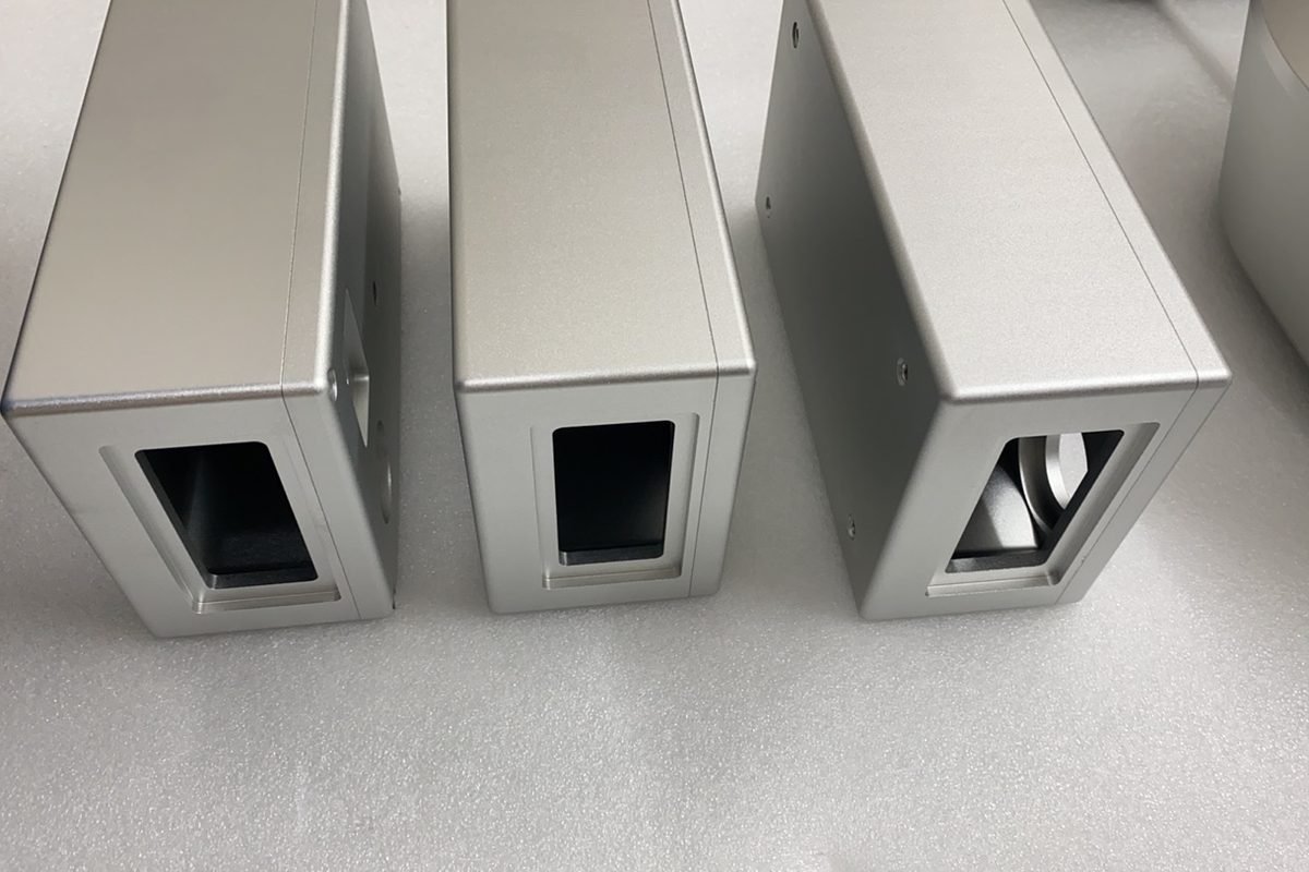 Three machined aluminum components