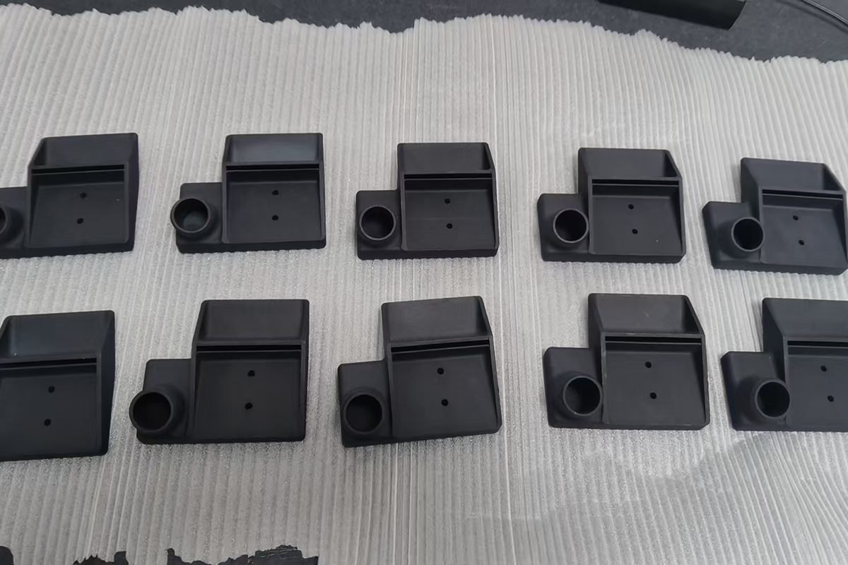 A production batch of 3D-printed components arranged in two rows