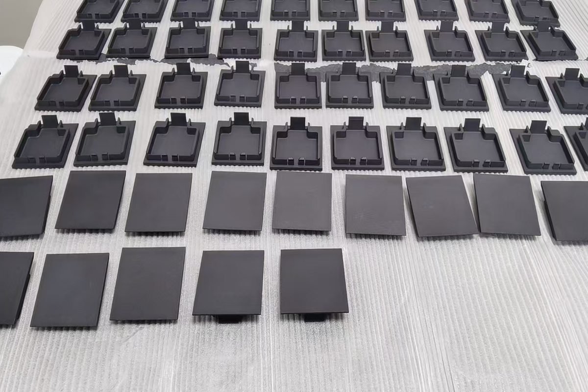 A production batch of 3D-printed polymer components laid out for inspection