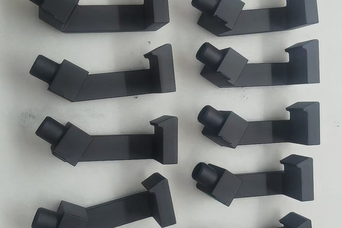 A production batch of custom 3D-printed components arranged in pairs